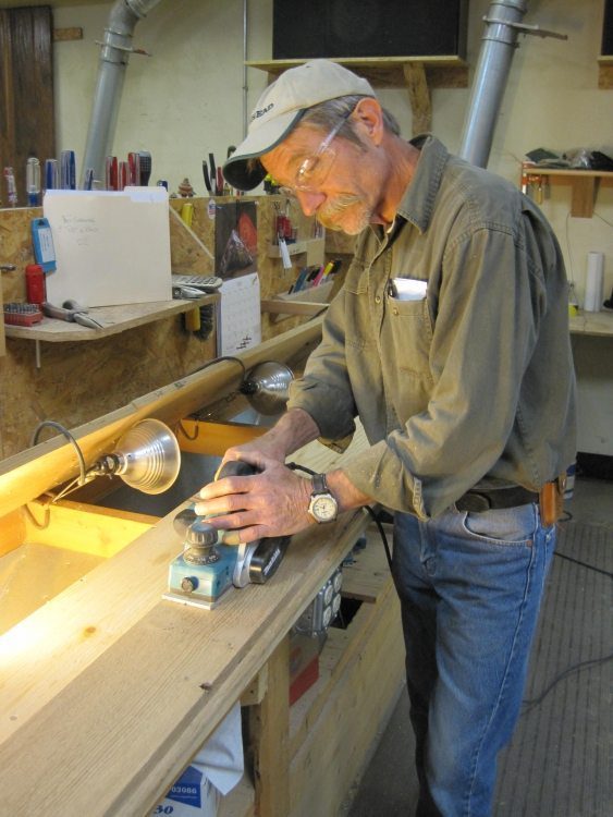John Cook, Carlisle Engineer, working on planks of wood