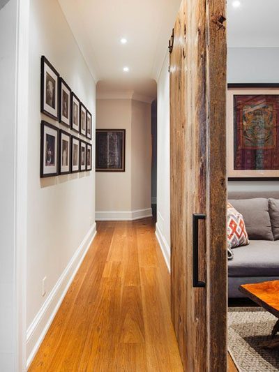 warn wood flooring in gallery style hallway