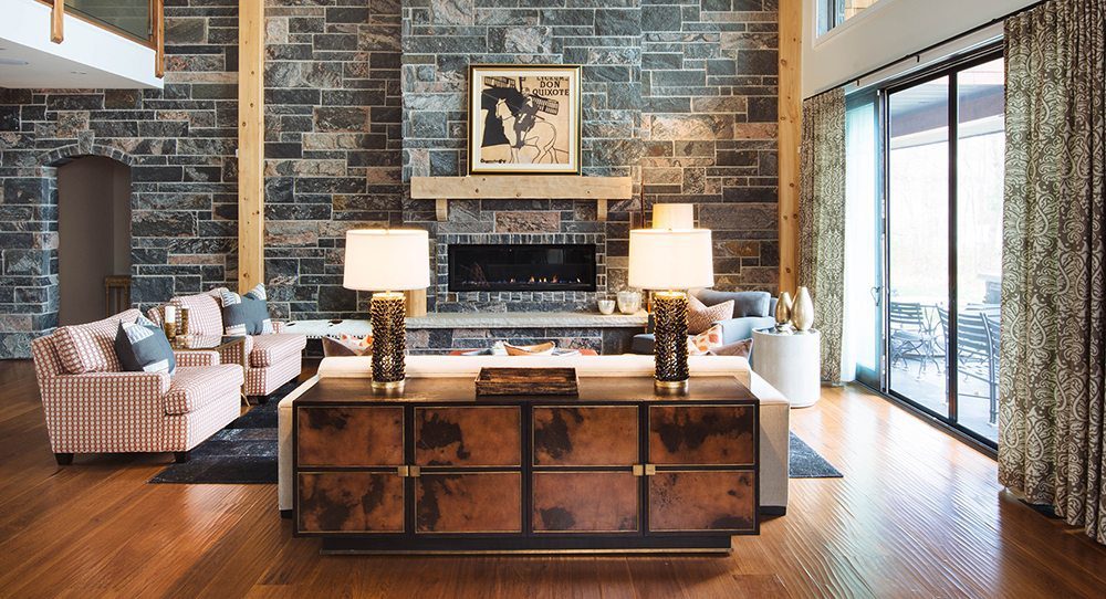 hardwood floor in Open concept living room with stone fireplace and bold patterns