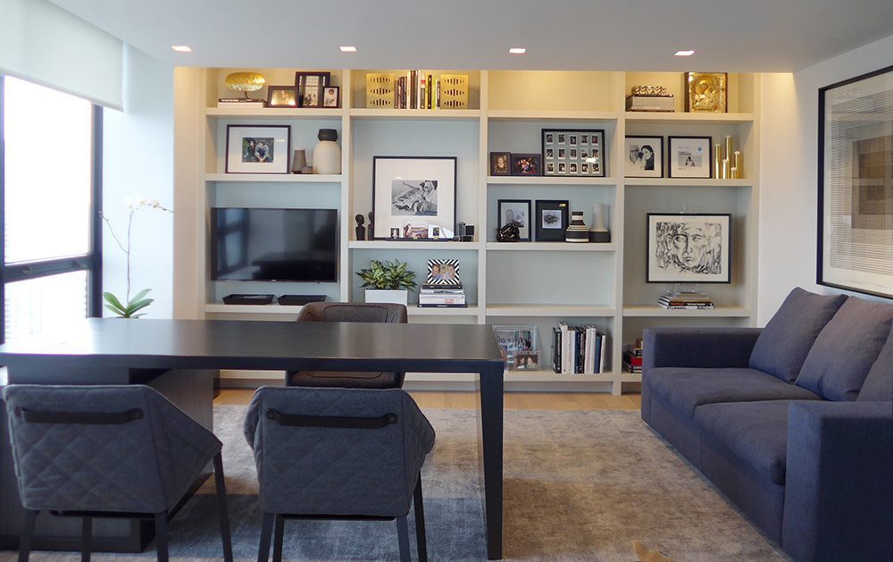 A contemporary office with natural wood floors and area rug